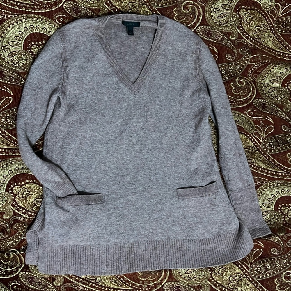 Soft pink oversized knit sweater with deep V-neck and front pockets